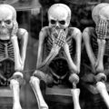 Three skeletons thinking of funny skeleton puns