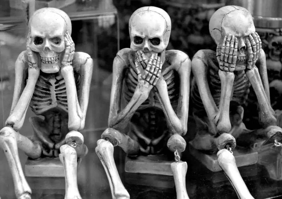 Three skeletons thinking of funny skeleton puns