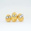 Three potatoes with funny looking eyes drawn on them