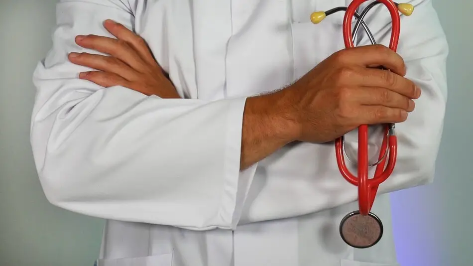 Doctor holding a stethoscope thinking of doctor jokes and puns