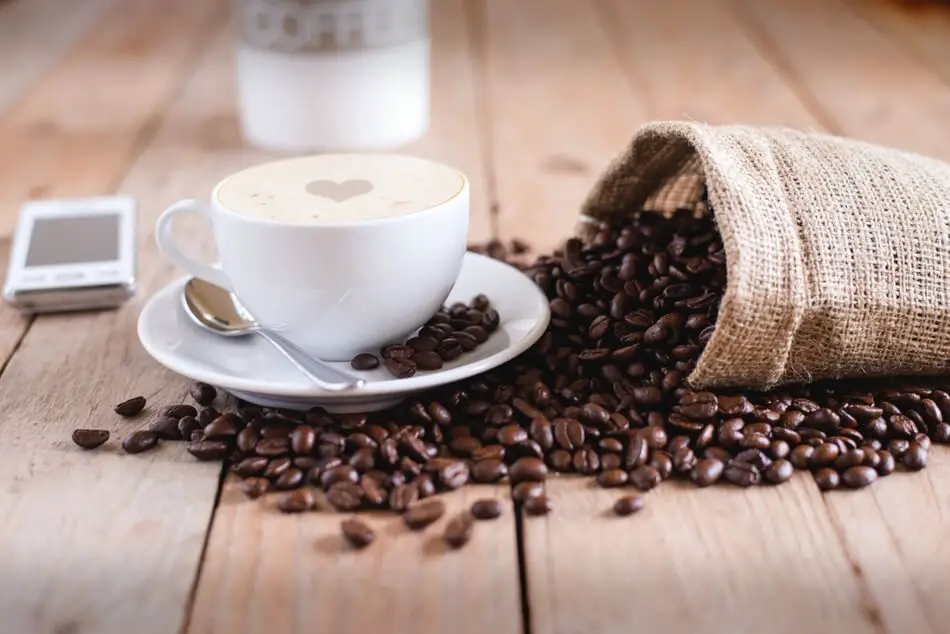 A macchiato on a table where people are telling coffee puns and coffee jokes