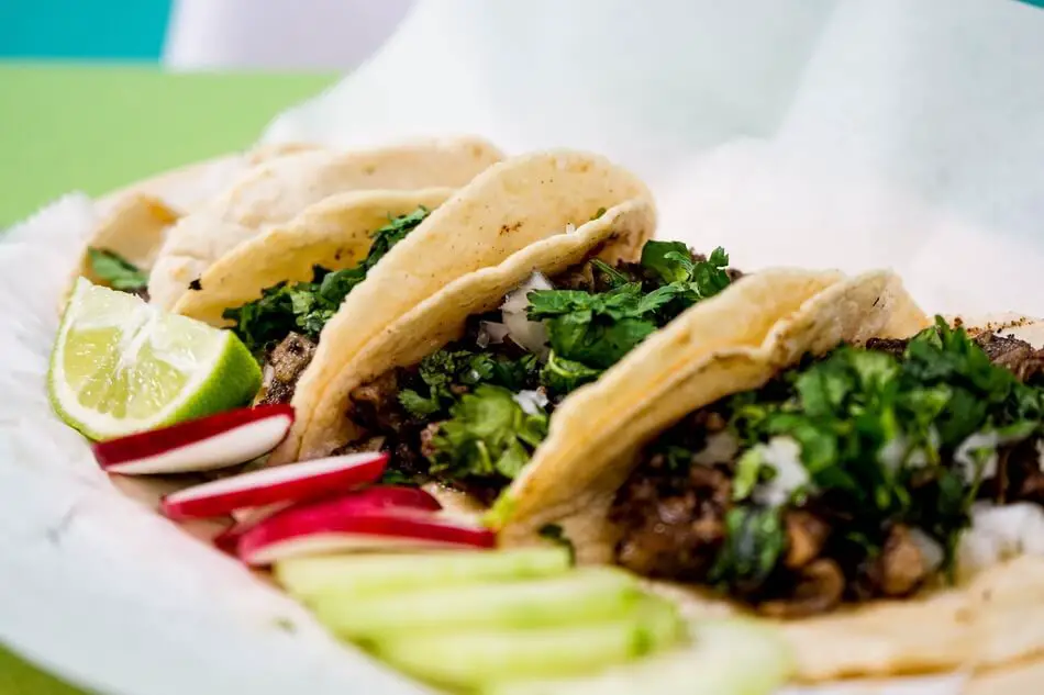 Tacos being served while people share taco puns and jokes