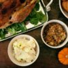 A table of food where people are sharing Thanksgiving jokes and puns