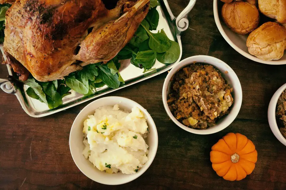 A table of food where people are sharing Thanksgiving jokes and puns
