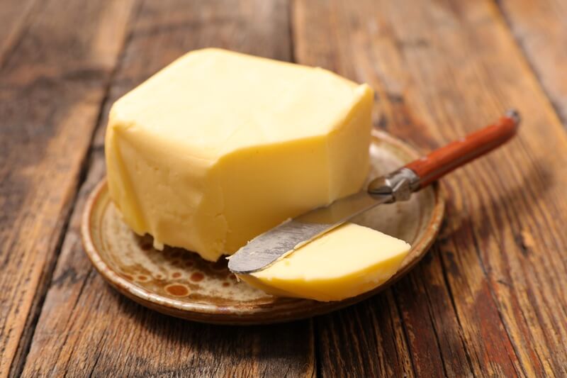Butter on the table while people tell puns and jokes about it