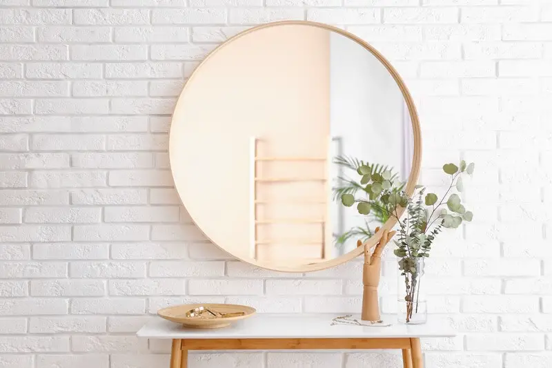 One mirror hanging on a wall